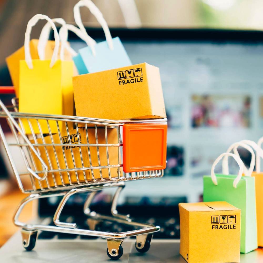 Shopping cart filled with colorful bags