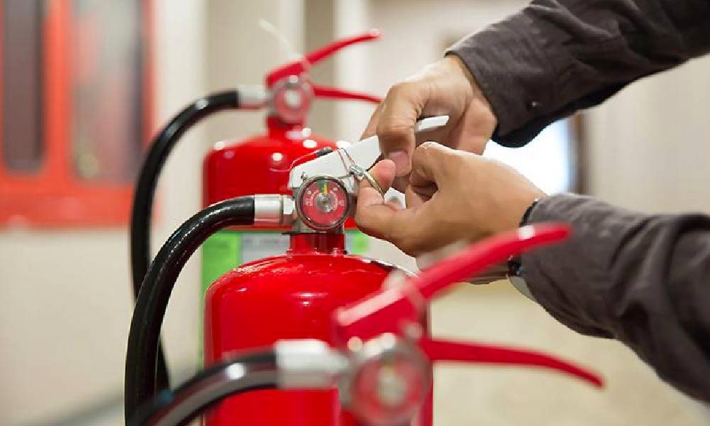 Technician checking a fire extinguisher